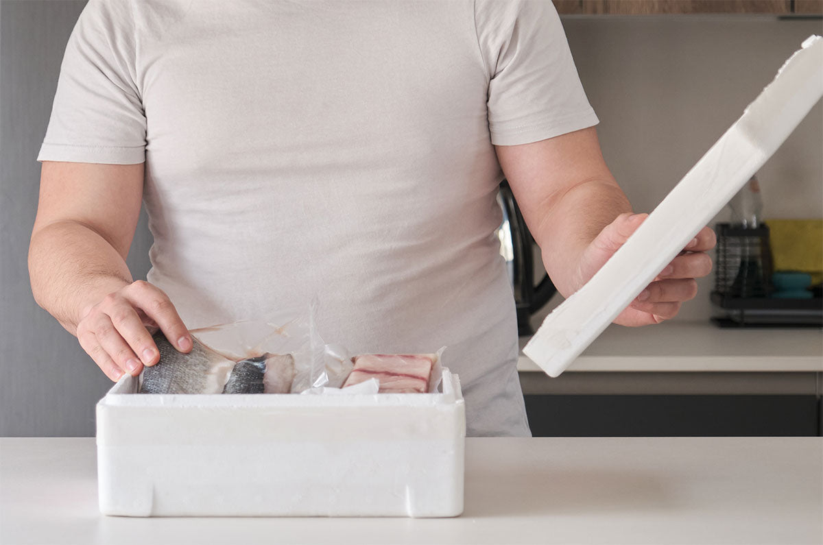 Person packing items into a polysytrene box